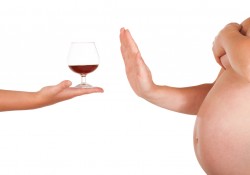 Pregnant woman rejects of taking glass of alcohol.