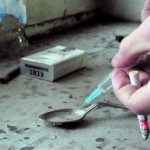 addict with heroin syringe fills