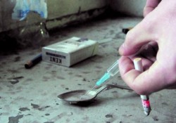 addict with heroin syringe fills